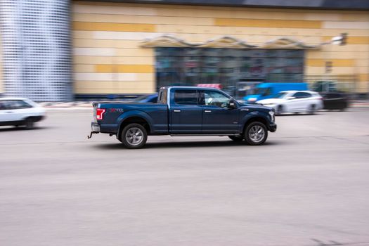 Ukraine, Kyiv - 26 April 2021: Black Ford F-150 car moving on the street. Editorial