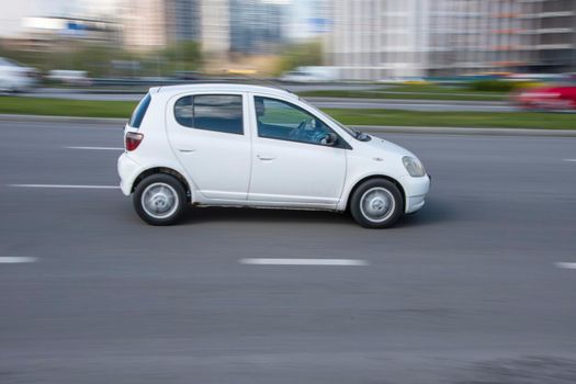 Ukraine, Kyiv - 26 April 2021: White Toyota Vitz car moving on the street. Editorial