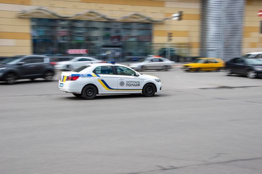 Ukraine, Kyiv - 26 April 2021: White Police Patrol car moving on the street. Editorial