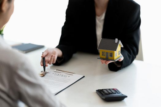 Real estate agents agree to buy a home and give keys to clients at their agency's offices. Concept agreement.