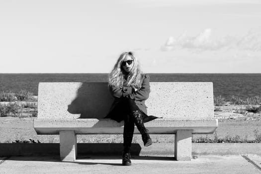 A beautiful girl with look angry is sitting on a bench