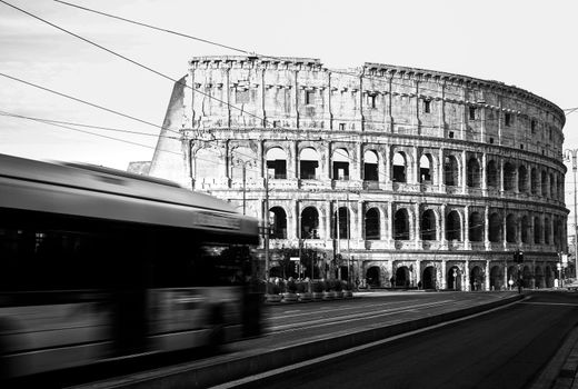 Roma, Italy, 27/11/2019: Rome Colosseum with buses moving in city traffic, travel reportage