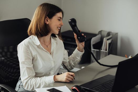 Female Manager Picks Up Phone, Young Woman Working at Office