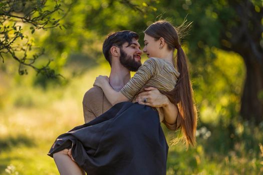 young couple hugging and kissing in nature