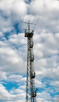  antenna for communications and television and radio with cloudy skies in the background