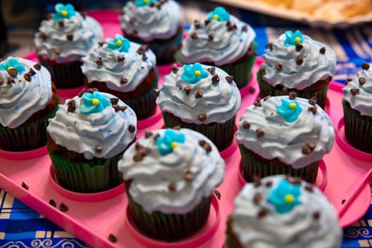 colorful cupcakes ready to eat and served on a pink tray; homemade pastry