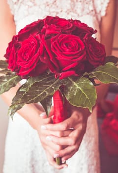 bride with bouquet of roses in hand during the wedding day