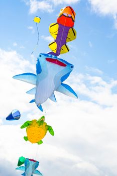 Flying kite with the shape of sea animals, manta, turtle and fish.