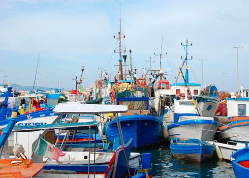 fishing boats floating in the port of a city in southern Italy