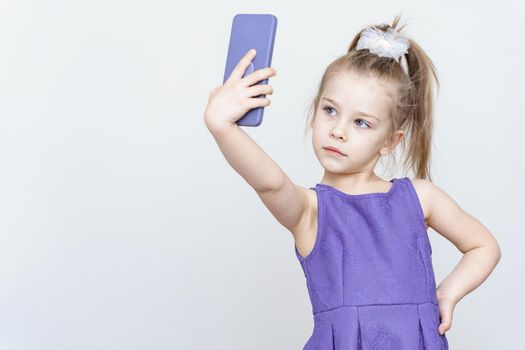cute little girl in blue dress taking a selfie