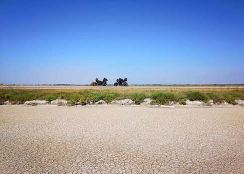 desert road with parked motorcycles