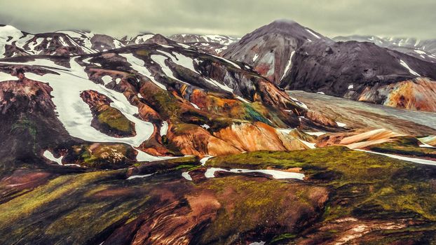 Aerial view landscape of Landmannalaugar surreal nature scenery in highland of Iceland, Europe. Beautiful colorful snow mountain terrain famous for summer trekking adventure and outdoor walking.