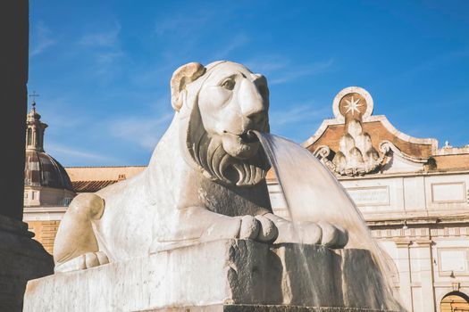 Roma, Italy, 26/11/2019: Piazza del Popolo in Rome, sculpture of the lion fountain with flowing water, travel reportage