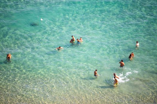 Ventimiglia, Italy, 14.07.2018: Boys playing on the beach of the Ligurian coast of Ventimiglia, during the summer holidays