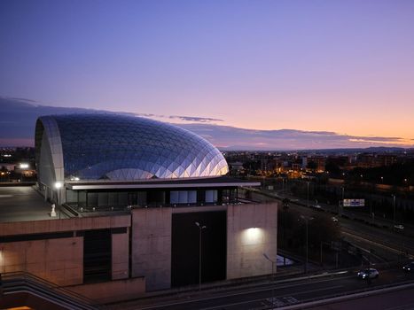 Modern building of the Trade Fair in Paterna in Valencia illuminated by the sunset