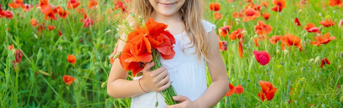 children girl in a field with poppies. selective focus.