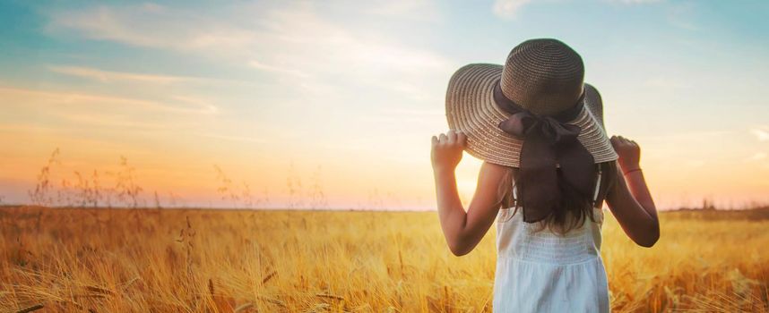 A child in a wheat field. Sunset. Selective focus. nature.