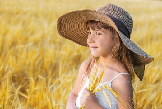 A child in a wheat field. Selective focus.