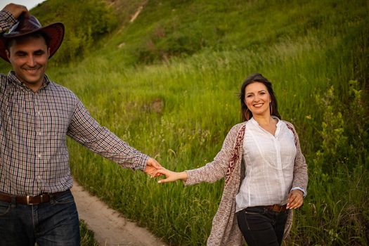 Young couple in Ukrainian shirts in a field with corn