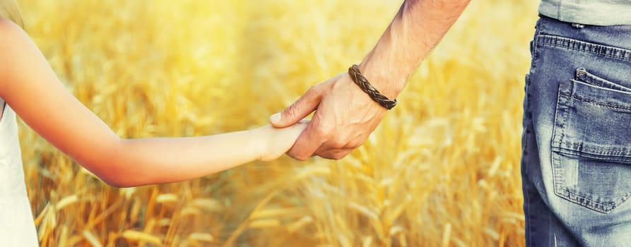Child and father in a wheat field. Selective focus. nature.
