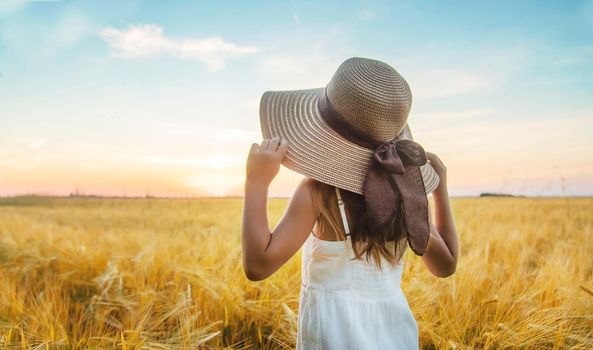 A child in a wheat field. Sunset. Selective focus. nature.