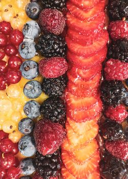 fruit cake seen from above, strawberries, raspberries, blueberries, 