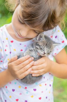 Little kittens in the hands of children. Selective focus.