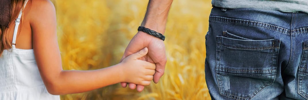 Child and father in a wheat field. Selective focus. nature.