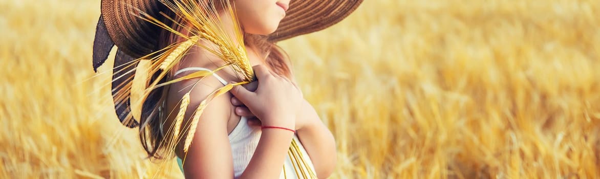 A child in a wheat field. Selective focus.