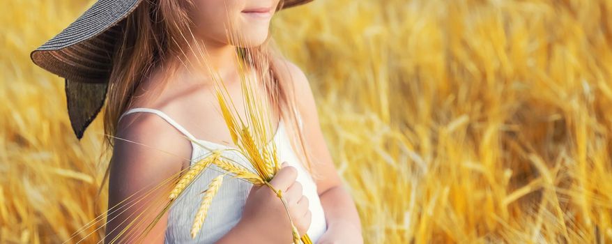 A child in a wheat field. Selective focus.