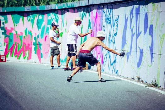 Imperia, Italy - 08/09/2018: Wall of Imperia city centre, Graffiti Artist Spray Painting Wall Art.