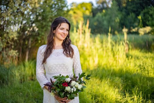 nice portrait of beautiful and young groom and bride outdoors