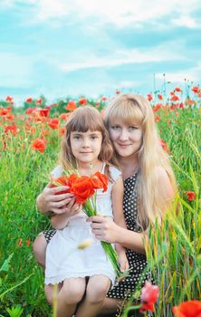 children girl in a field with poppies. selective focus.