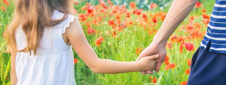 children girl in a field with poppies. selective focus. nature.