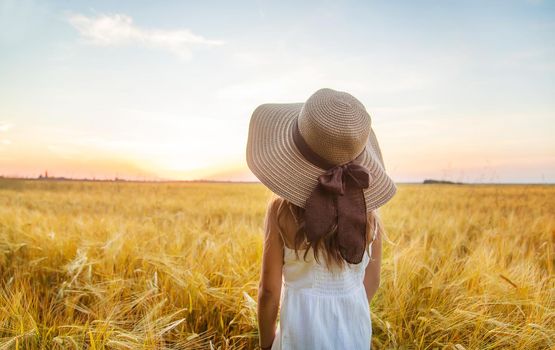 A child in a wheat field. Sunset. Selective focus. nature.