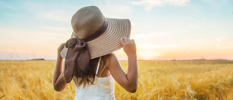 A child in a wheat field. Sunset. Selective focus. nature.