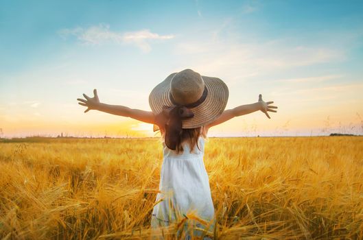 A child in a wheat field. Sunset. Selective focus. nature.