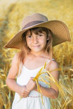 A child in a wheat field. Selective focus.