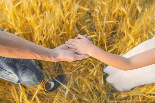 Child and father in a wheat field. Selective focus. nature.