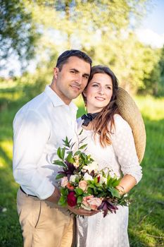 nice portrait of beautiful and young groom and bride outdoors