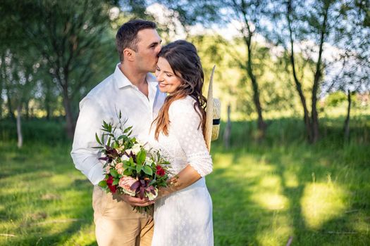 nice portrait of beautiful and young groom and bride outdoors