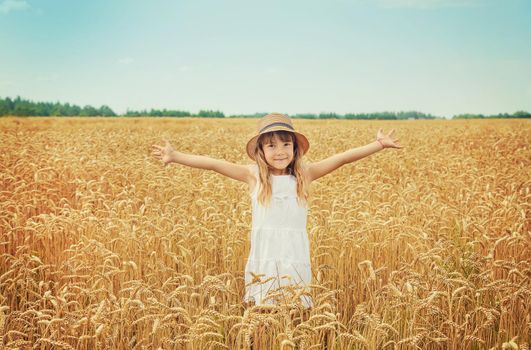 A child in a wheat field. Selective focus.