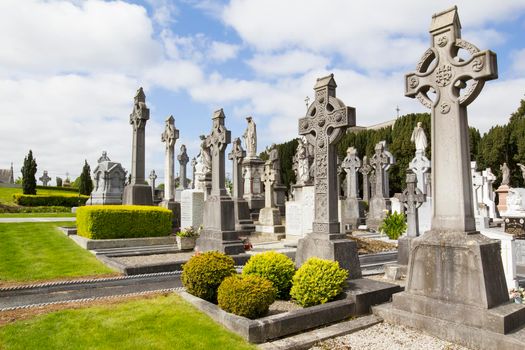 A beautiful Irish cemetery. ----- Ireland, Dublin - May 22, 2015: photograph of the cemetery in Dublin on a beautiful sunny day, there are many stone tombstones.
