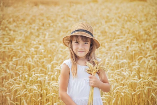 A child in a wheat field. Selective focus.