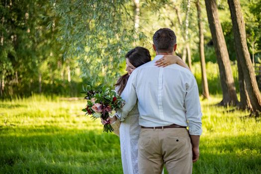 nice portrait of beautiful and young groom and bride outdoors