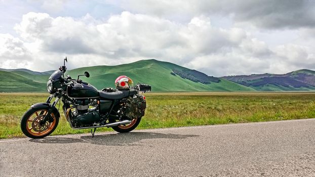 mountainous landscape with parked motorcycle