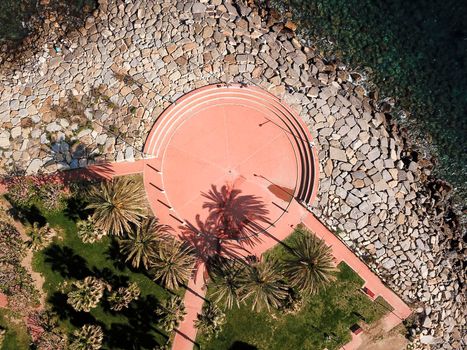View from the top of a square located near the sea of the Ligurian coast in Italy, photo taken with a drone.