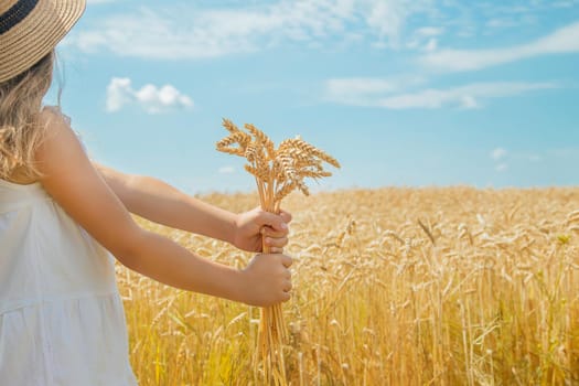A child in a wheat field. Selective focus. nature.