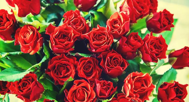 Bouquet of red roses, a gift for Valentine's Day. Selective focus. Holiday.