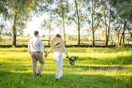 nice portrait of beautiful and young groom and bride outdoors